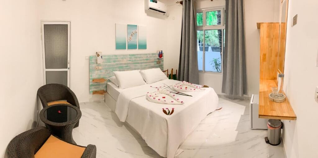 Room with wicker chair, window and marble floor